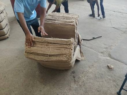 Jute bags being baled and stacked, photo 1 of 3