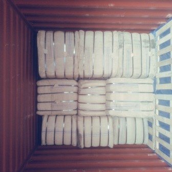 Bales of jute bags stacked inside a shipping container, photo 1 of 25