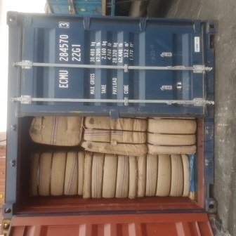 Bales of jute bags stacked inside a shipping container, photo 2 of 25