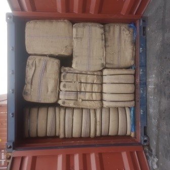 Bales of jute bags stacked inside a shipping container, photo 3 of 25