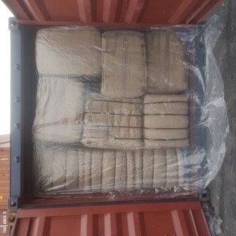 Bales of jute bags stacked inside a shipping container, photo 4 of 25