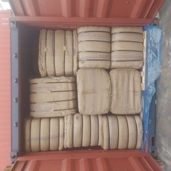 Bales of jute bags stacked inside a shipping container, photo 6 of 25