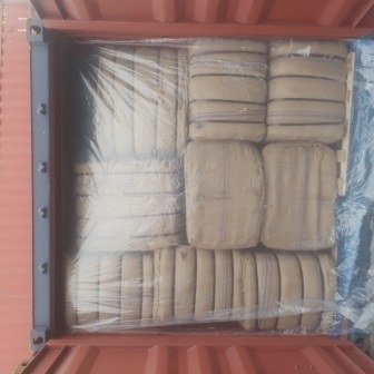 Bales of jute bags stacked inside a shipping container, photo 10 of 25
