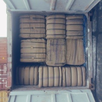 Bales of jute bags stacked inside a shipping container, photo 12 of 25