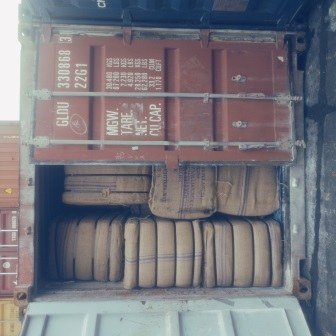 Bales of jute bags stacked inside a shipping container, photo 13 of 25