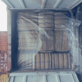 Bales of jute bags stacked inside a shipping container, photo 14 of 25