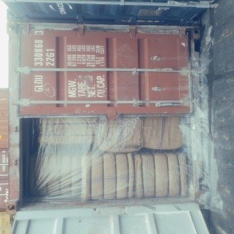Bales of jute bags stacked inside a shipping container, photo 15 of 25