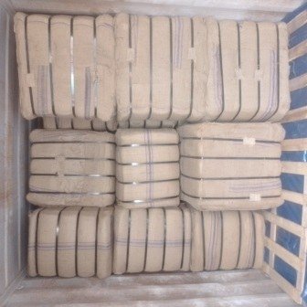 Bales of jute bags stacked inside a shipping container, photo 16 of 25