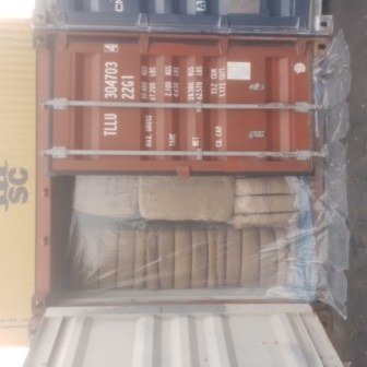Bales of jute bags stacked inside a shipping container, photo 24 of 25