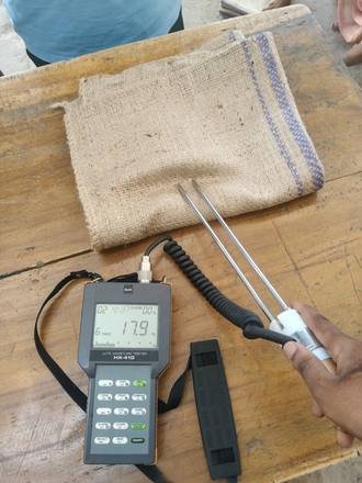 Moisture meter checking a jute bag, photo 2 of 4