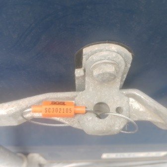 Container doors closed with a numbered seal, photo 1 of 10