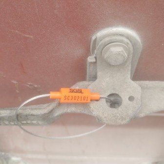 Container doors closed with a numbered seal, photo 4 of 10