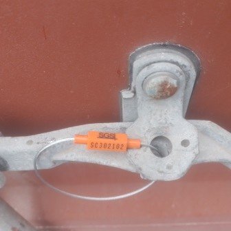 Container doors closed with a numbered seal, photo 5 of 10