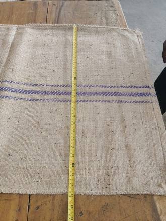 Measuring a jute bag with a tape, photo 6 of 21