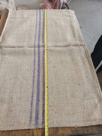 Measuring a jute bag with a tape, photo 8 of 21