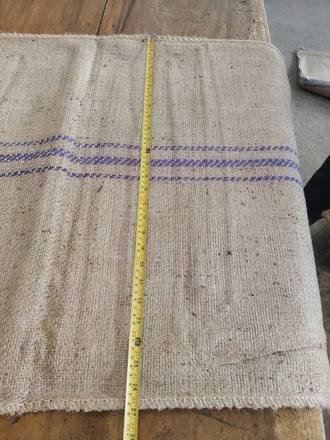 Measuring a jute bag with a tape, photo 11 of 21
