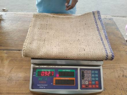 Jute bag being weighed on a digital scale, photo 2 of 9