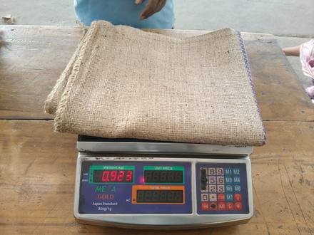 Jute bag being weighed on a digital scale, photo 3 of 9