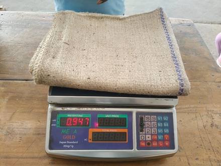 Jute bag being weighed on a digital scale, photo 4 of 9
