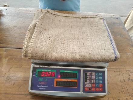 Jute bag being weighed on a digital scale, photo 5 of 9