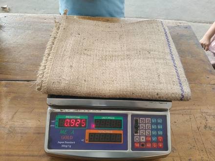 Jute bag being weighed on a digital scale, photo 6 of 9