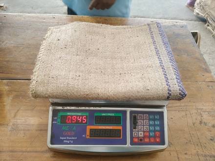 Jute bag being weighed on a digital scale, photo 7 of 9