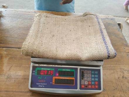 Jute bag being weighed on a digital scale, photo 8 of 9