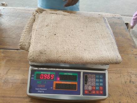 Jute bag being weighed on a digital scale, photo 9 of 9